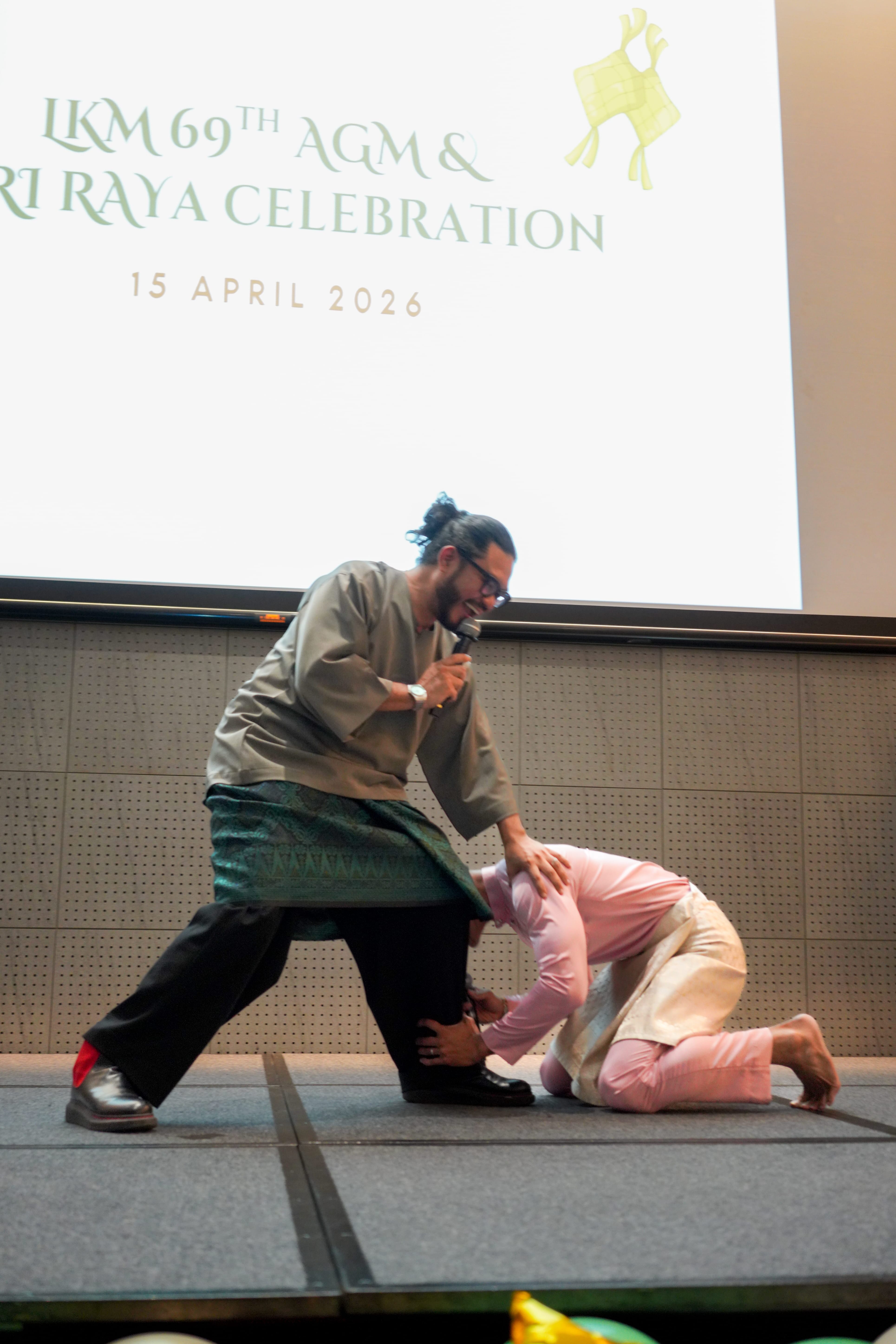 A performer playfully acting out a comedic skit on stage.